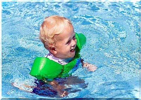 baby playing in the pool