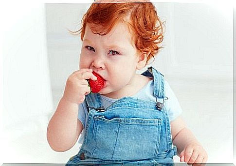 baby eating strawberry