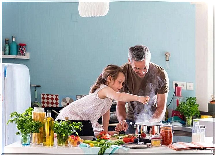 father and daughter cooking at home