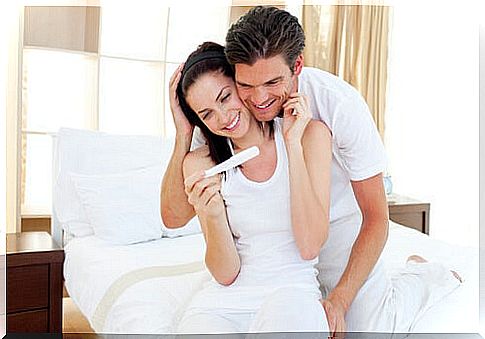 Couple looking at pregnancy test result together.