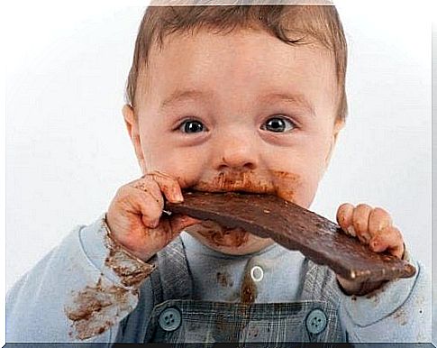 baby eating a chocolate bar