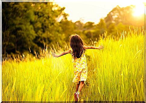 girl running through the tall grass