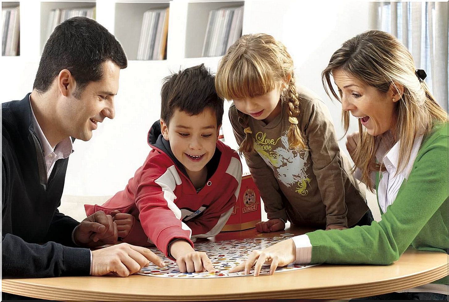 father, mother and children playing together